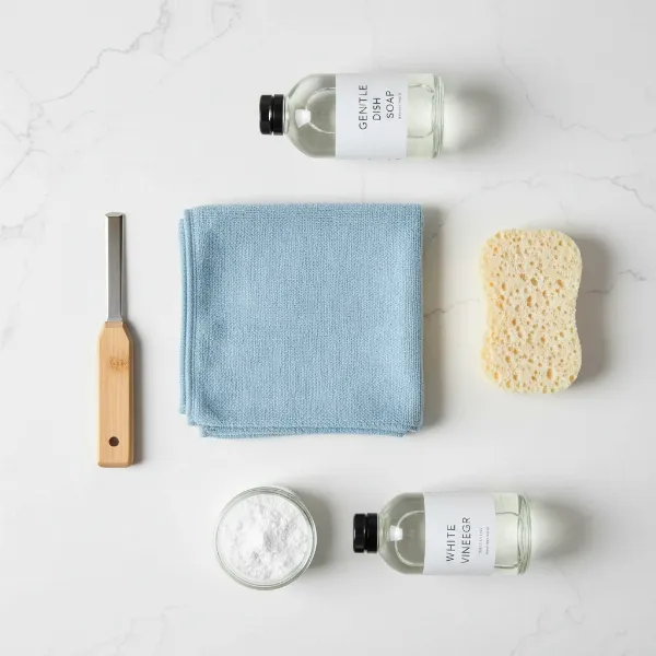 Essential tools for cleaning a rice cooker heating plate: soft cloth, sponge, soap, baking soda, vinegar.