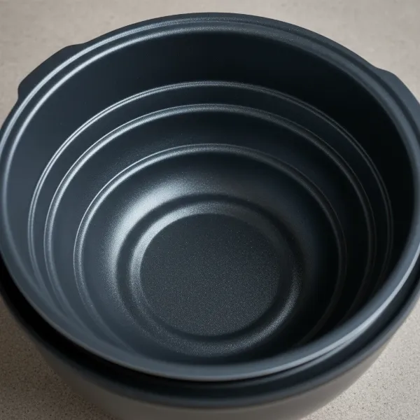 Close-up of the Tefal RK8121's five-layer spherical non-stick inner pot.